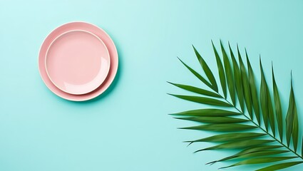 Two Pink Ceramic Plates Sit on a Light Blue Background with Green Palm Leaves