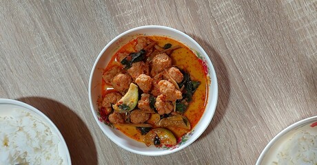 Spicy Thai curry with meatballs eggplant and fresh basil served with white rice