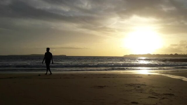 A view of the sea and the sky at sunset in the summer in the Aceh province area, with a man enjoying the beauty of the sunset.