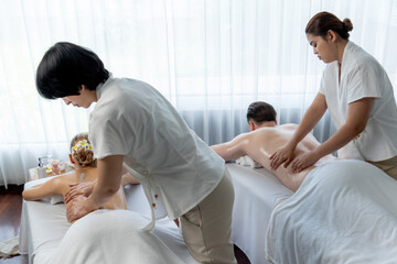 Caucasian couple customer enjoying relaxing anti-stress spa massage and pampering with beauty skin...