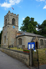 Oxton, Nottinghamshire, England - June 20 2025: Traditional stone church with clock tower, Union...