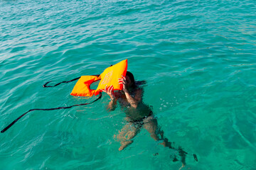 Drowning person holding water rescue emergency equipment. Safety water equipment.