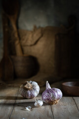 Unpeeled garlic on a rustic table