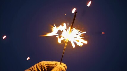 Celebration with colorful sparkler lighting up the night sky in an outdoor gathering - Powered by Adobe