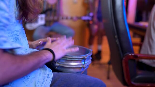 Musician playing darbuka drum in recording studio