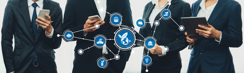 A group of business professionals engaged with mobile devices while showcasing icons of technology and connectivity, symbolizing modern corporate communication and collaboration. Amity