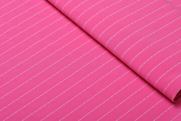 Flatlay of pink suiting fabric with white line pattern—ideal textile background for fashion,...