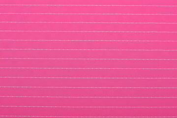 Flatlay of pink suiting fabric with white line pattern—ideal textile background for fashion,...