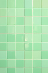 Fototapeta premium Glossy Mint Green Ceramic Tile Wall Background Seamless Grid of Light Green Square Tiles with Shine
