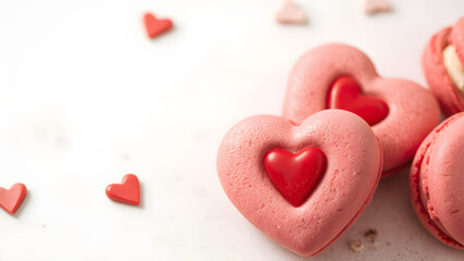 Obraz premium Close-up of red heart-shaped macarons filled with cream