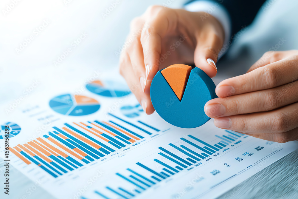 Poster close up of hands holding colorful pie chart with blue and orange segments, surrounded by various gr