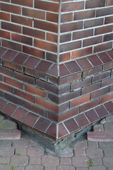 Architectural corner junction of red brick building displaying classic European construction...