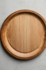 Simple round wooden tray with natural grain and flat surface, captured from top view in studio.

