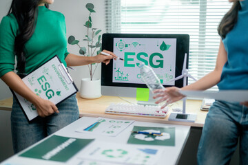 Colleagues collaborate on ESG initiatives at a modern workspace