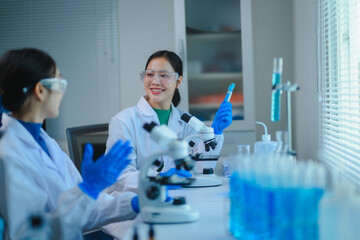 Researchers discussing experiments with microscopes and test tubes