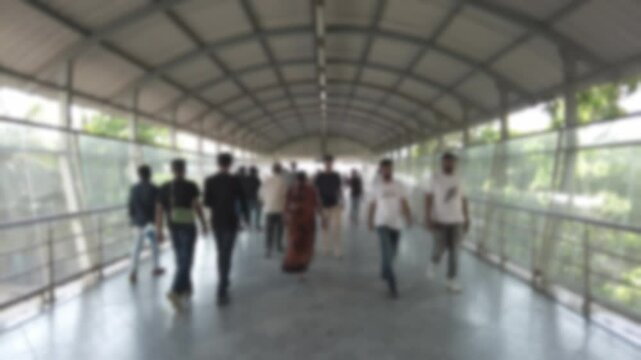 Slow motion bokeh video of people walking on the overpass in Mumbai, India. Blurred video of human traffic for background.