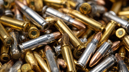 Closeup of Shiny Metallic Bullets and Cartridges in Pile Representing Ammunition, War, and Tactical Combat