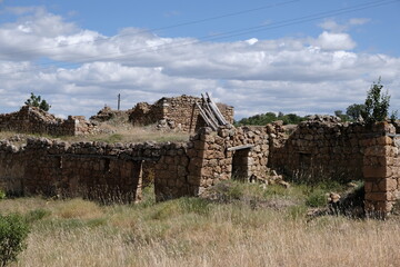 A barn made of stone and soil used as an animal shelter in a village in Turkey, now in ruins