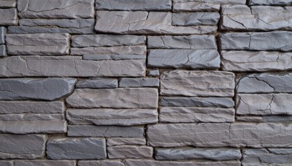 Fototapeta premium Close-Up View of Layered Gray Stone Wall Texture in Modern Architectural Design