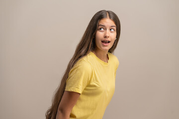 Obraz premium Surprised young woman with a guilty expression as if caught eavesdropping.