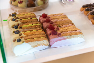 Colorful dessert display featuring cream-filled pastries in a bakery shop