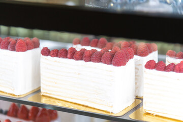 Delicious raspberry cakes displayed in a bakery