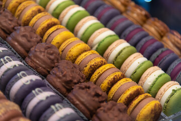 Colorful array of macarons displayed at a pastry shop in the afternoon