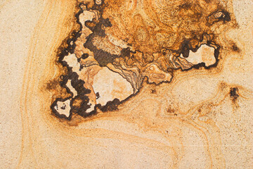 Close-up of natural sandstone texture with layered mineral patterns and warm earthy tones. Abstract...