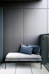 Stylish loft balcony featuring modern furniture and gray accents for relaxation