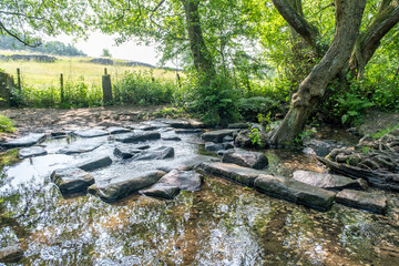Stepping stones across a small river, stream or brook in Lumsdale Valley, Matlock