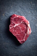A juicy cut of raw beef, its vibrant red hue and intricate marbling hinting at a flavorful meal ahead