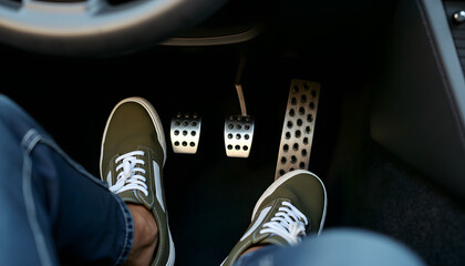 Feet in sneakers are shown pressing the car pedals, emphasizing driving experience.