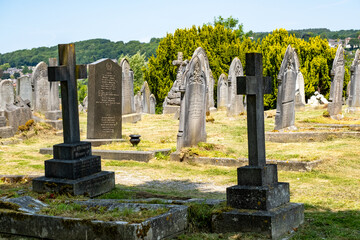 Ornately carved cross head stones on graves in the churchyard of St Giles Church
