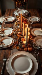 Warm autumn dinner table setting with candles, pumpkins, and seasonal decor