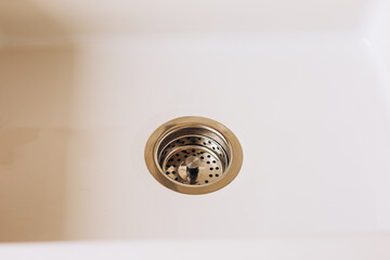 Drain in a modern kitchen sink captures everyday life and functionality in a bright space