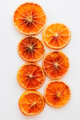 Dried orange slices arranged on a light background for decorative purposes and culinary uses