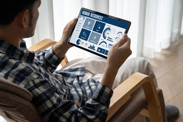 Human resources management software on computer screen helping human resources employee to manage...