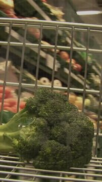 Animation of statistics and data over vegetables in baskets in supermarket