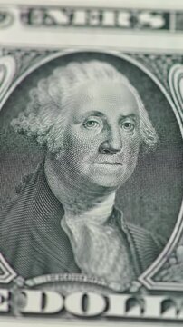 Extreme close-up macro dolly pan video across pristine american dollar bills, revealing intricate alexander hamilton on ten-dollar and george washington on one-dollar with detailed texture, security