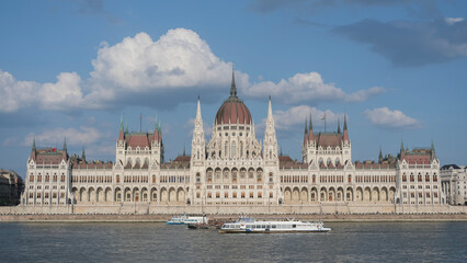 The Hungarian Parliament building during the day, with its majestic architecture and intricate design, set against a clear blue sky.