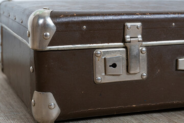 Close-up vintage old classic travel leather suitcase circa 1940-60s. Travel luggage concept. Retro...