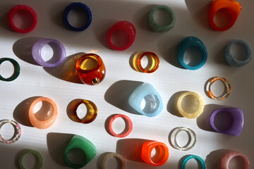 Collection of colorful plastic rings on white background. Top view.
