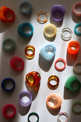 Collection of colorful plastic rings on white background. Top view.