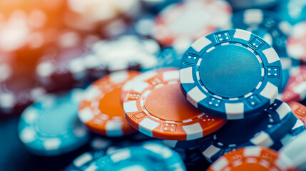 A vibrant arrangement of blue and orange poker chips with soft light bokeh, capturing the excitement of a casino game night, suitable for gaming promotions and entertainment banners.