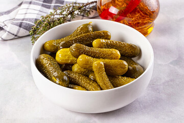 Marinated canned green cornichon cucumbers