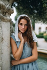 Woman in Blue Dress and Lace Head Covering