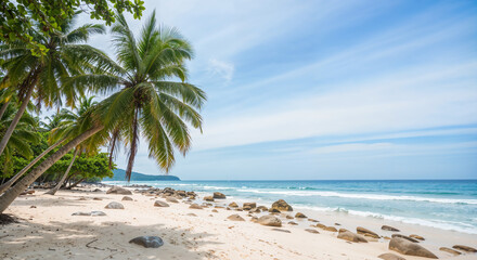 Fototapeta premium Tropical beach with palm trees, rocks, and clear blue sky on sunny day