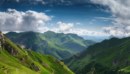 Naklejka premium breathtaking view of green mountains under a blue sky with fluffy clouds in the background during a sunny day