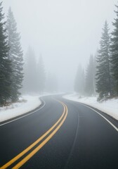 Obraz premium Winding mountain road through a foggy winter forest landscape