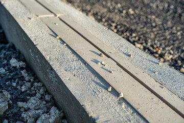 Construction photo of new running track slot drain in concrete.
